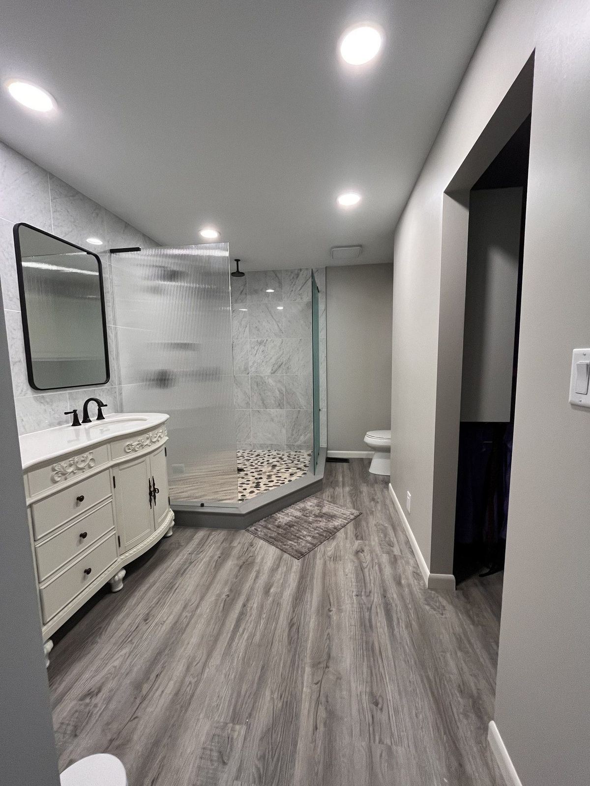 Bathroom remodel with marble tile by DK Dynamics