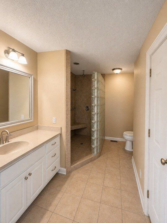 Hewitt bathroom before — glass block shower, dated finishes