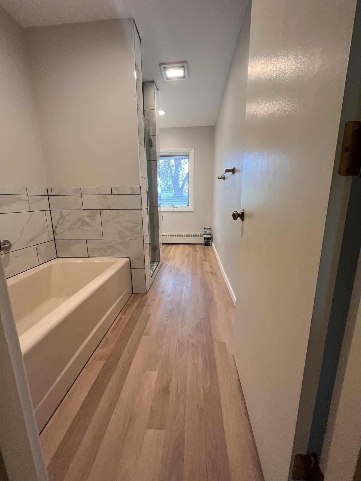 Full bathroom renovation with new tub and tile by DK Dynamics