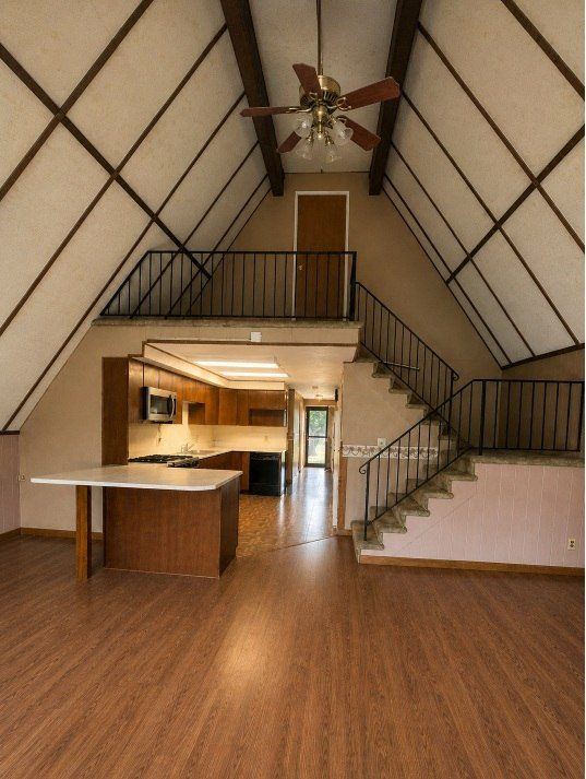 LeSalle great room before — dated A-frame interior with brown finishes and old kitchen