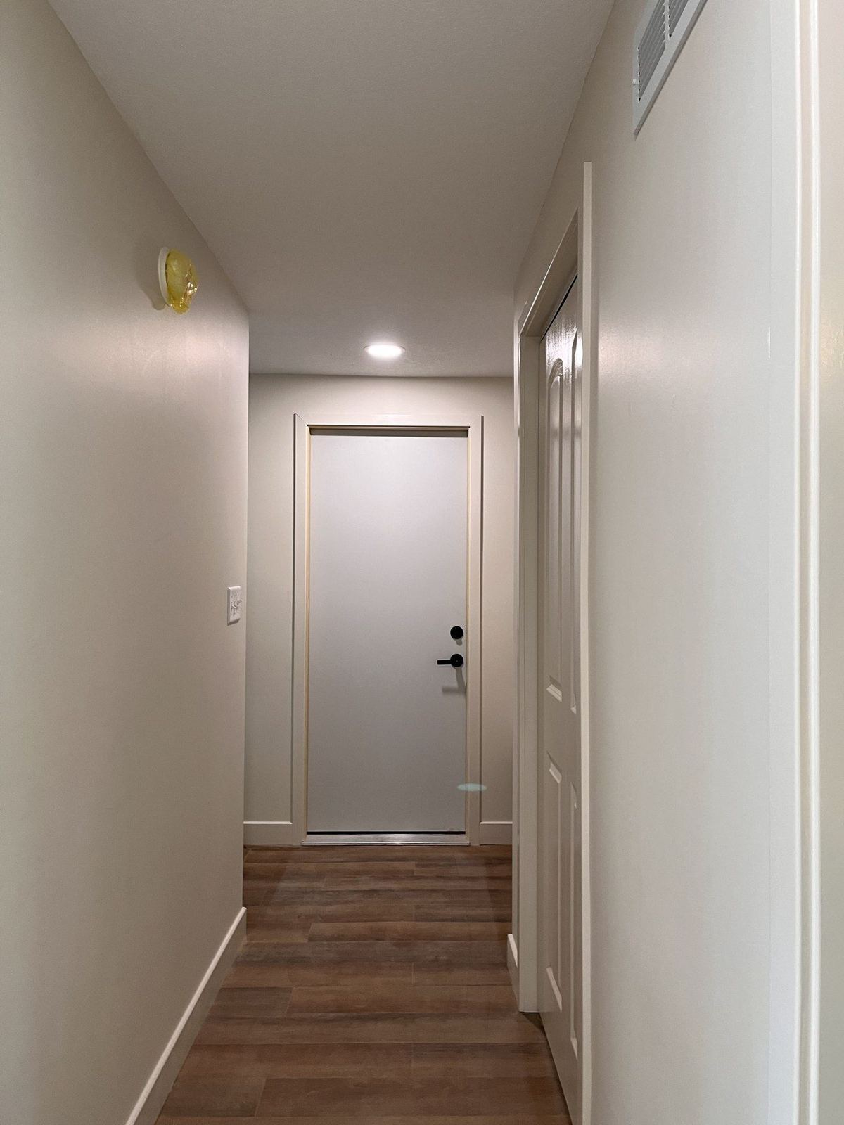 Renovated hallway with new flooring and fresh paint
