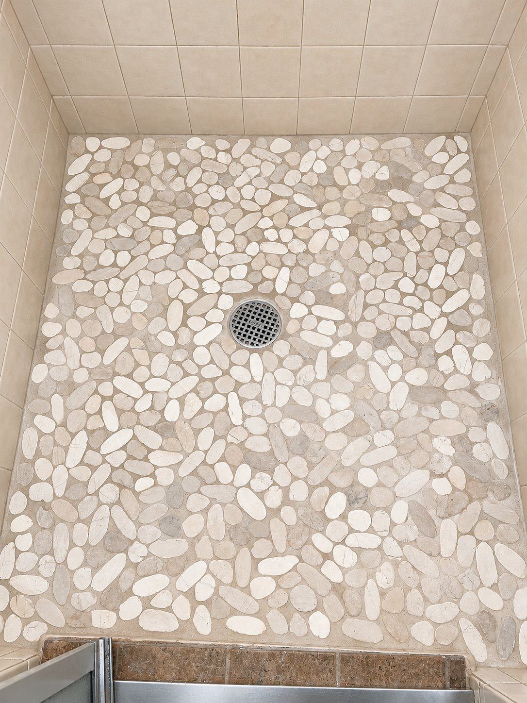 Pebble tile shower floor by DK Dynamics
