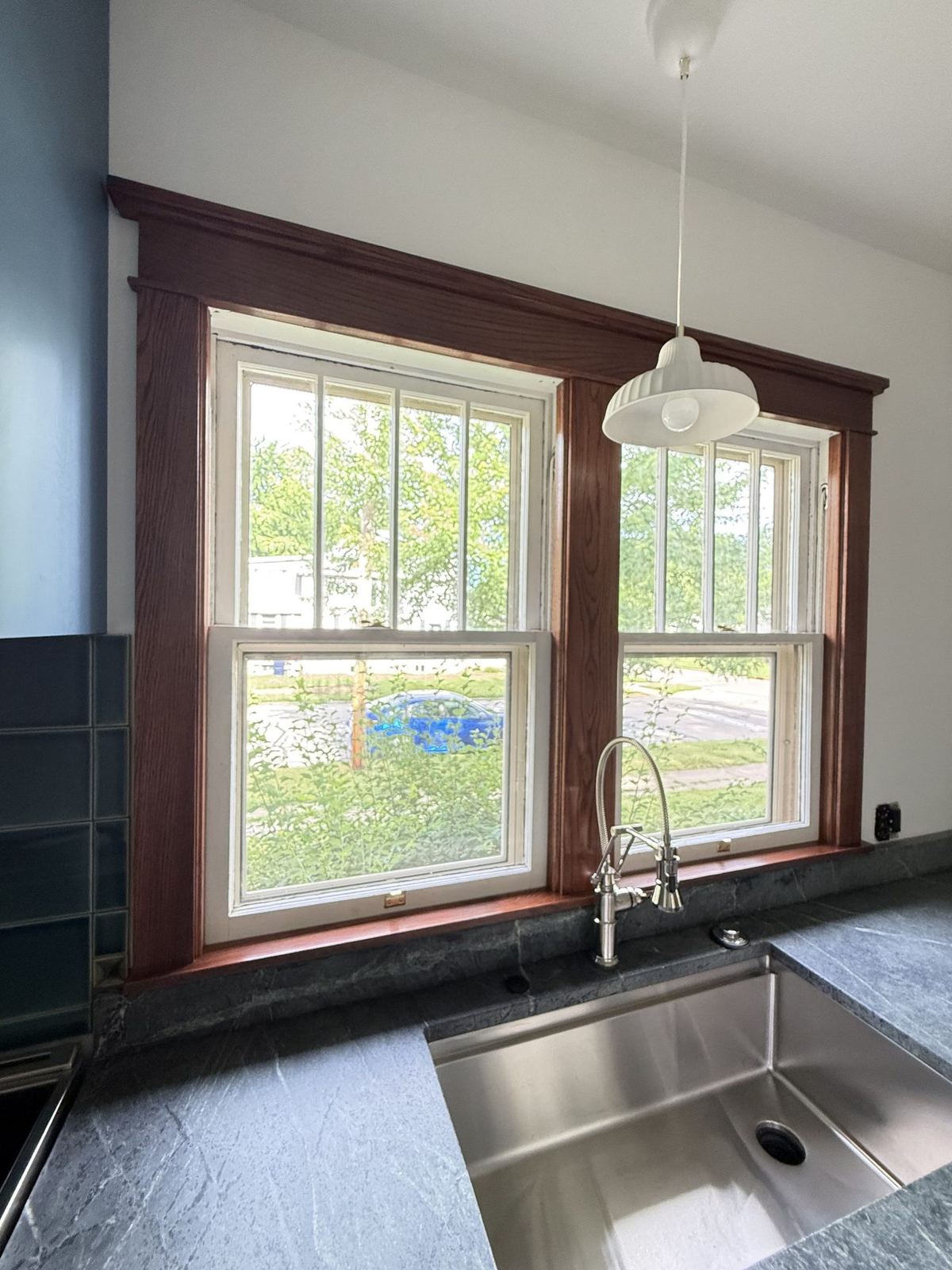 Sink area with custom window trim and soapstone countertops